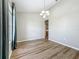 Bright dining room with wood-look floors, modern chandelier, and large window at 301 Terranova Blvd, Winter Haven, FL 33884