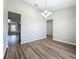 Bright dining room boasts wood-look floors, modern lighting, and open space at 301 Terranova Blvd, Winter Haven, FL 33884