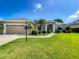 Beautiful single-story home featuring lush landscaping and a well-manicured lawn at 301 Terranova Blvd, Winter Haven, FL 33884