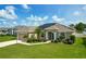 Charming single-story home boasting lush landscaping and a well-manicured lawn at 301 Terranova Blvd, Winter Haven, FL 33884