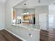 Modern kitchen with marble countertops, stainless steel appliances, and oak cabinets at 301 Terranova Blvd, Winter Haven, FL 33884
