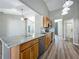 Open-concept kitchen with wood cabinets, stainless appliances, and a large island with a marble countertop at 301 Terranova Blvd, Winter Haven, FL 33884
