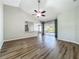 Open-concept living room with wood floors, a ceiling fan and natural light at 301 Terranova Blvd, Winter Haven, FL 33884