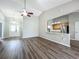 Open-concept living room with hardwood floors and open view to kitchen at 301 Terranova Blvd, Winter Haven, FL 33884