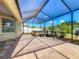 The covered patio has a spa and is surrounded by tropical landscaping at 301 Terranova Blvd, Winter Haven, FL 33884