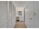 Hallway view into bathroom with dual closets, vanity, and toilet/shower room at 3205 Sabal Palms Ct # A, Kissimmee, FL 34747