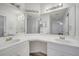 Well-lit bathroom featuring dual sinks, vanity area, and large mirrors at 3205 Sabal Palms Ct # A, Kissimmee, FL 34747