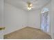 The bright bedroom features carpet, a ceiling fan, and a window with floral curtains at 3205 Sabal Palms Ct # A, Kissimmee, FL 34747