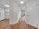 Hallway with wood floors leading to the kitchen and living area with white appliances at 3205 Sabal Palms Ct # A, Kissimmee, FL 34747