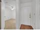 Hallway with wood floors leading to a room with carpet and a ceiling fan at 3205 Sabal Palms Ct # A, Kissimmee, FL 34747