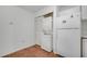 A convenient laundry area with a stacked washer and dryer next to the refrigerator at 3205 Sabal Palms Ct # A, Kissimmee, FL 34747