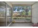 View of the screened-in patio with beige carpet and an outdoor view at 3205 Sabal Palms Ct # A, Kissimmee, FL 34747
