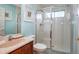 A well-lit bathroom features a shower, vanity with sink, and framed pictures on the wall at 344 Cherokee Ave, Haines City, FL 33844