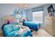 The 'Frozen' themed bedroom has twin beds, a mural, and a light fixture; a whimsical and inviting space at 344 Cherokee Ave, Haines City, FL 33844