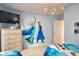 'Frozen' themed bedroom with a large wall mural, dresser, and comfortable twin beds at 344 Cherokee Ave, Haines City, FL 33844