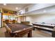 Finished basement with a pool table, game table and bar area, ideal for entertaining at 344 Cherokee Ave, Haines City, FL 33844