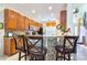 Well-lit kitchen with granite countertops, wooden cabinets, and seating at the bar at 344 Cherokee Ave, Haines City, FL 33844