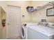 Well-lit laundry room with a washer and dryer for convenient home chores at 344 Cherokee Ave, Haines City, FL 33844