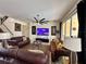 Spacious living room with multiple seating areas and a large ceiling fan for comfort at 344 Cherokee Ave, Haines City, FL 33844