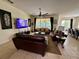 Spacious living room with comfortable leather furniture and a view of the screened-in pool at 344 Cherokee Ave, Haines City, FL 33844