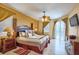 Comfortable main bedroom features stylish decor, a ceiling fan, and natural light at 344 Cherokee Ave, Haines City, FL 33844