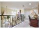 Upstairs landing with staircase and natural light, offering a versatile space at 344 Cherokee Ave, Haines City, FL 33844