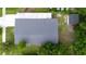 Aerial view of a residential property, highlighting the roof, surrounding greenery, and nearby structures at 3524 Hage Way, Orlando, FL 32805