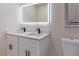 Bathroom featuring double sinks, black fixtures, and a lighted mirror at 3524 Hage Way, Orlando, FL 32805