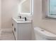 Bathroom featuring double sinks, black fixtures, and lighted mirror at 3524 Hage Way, Orlando, FL 32805