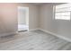 Empty bedroom featuring light walls, light wood floors, and natural light at 3524 Hage Way, Orlando, FL 32805