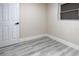 Neutral bedroom featuring wood-look floors, base trim and a window at 3524 Hage Way, Orlando, FL 32805