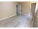 Spacious bedroom with wood-look floors, base trim and an open doorway at 3524 Hage Way, Orlando, FL 32805