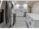 Spacious renovated kitchen featuring white cabinets, stainless steel appliances, and modern vinyl flooring at 3524 Hage Way, Orlando, FL 32805