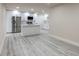 Spacious updated kitchen featuring white cabinets, stainless steel appliances, and stylish vinyl flooring at 3524 Hage Way, Orlando, FL 32805