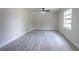 Bright living room featuring modern vinyl flooring, ceiling fan, neutral paint, and plenty of natural light at 3524 Hage Way, Orlando, FL 32805