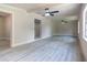 Bright living room featuring modern vinyl flooring, ceiling fans, neutral paint, and abundant natural light at 3524 Hage Way, Orlando, FL 32805