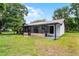 Exterior of the screened-in porch and backyard of the property at 3623 Tree Line Way, St Cloud, FL 34769
