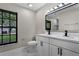 Bathroom featuring a double vanity with modern fixtures and a window at 3623 Tree Line Way, St Cloud, FL 34769