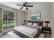 Comfortable bedroom featuring a large window, ceiling fan and calming decor at 3623 Tree Line Way, St Cloud, FL 34769