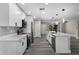 Bright, open kitchen with white cabinetry, stainless steel appliances, and sleek, gray tile backsplash at 3623 Tree Line Way, St Cloud, FL 34769