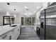Modern kitchen with stainless steel appliances, a sleek island, and bright, contemporary lighting at 3623 Tree Line Way, St Cloud, FL 34769