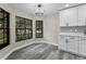 Eat-in kitchen nook features luxury vinyl plank flooring, stylish lighting, and large windows at 3623 Tree Line Way, St Cloud, FL 34769