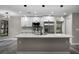 Bright, updated kitchen with an island, stainless steel appliances, and contemporary lighting at 3623 Tree Line Way, St Cloud, FL 34769