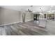 Open-concept living room with luxury vinyl plank flooring and access to the kitchen and screened patio at 3623 Tree Line Way, St Cloud, FL 34769
