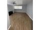Bright bedroom featuring beautiful wood floors and a large window, creating a cozy atmosphere at 400 Vermont Ave, St Cloud, FL 34769