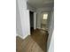 Hallway with woodgrain vinyl flooring leading to bedrooms at 400 Vermont Ave, St Cloud, FL 34769