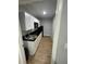 Well lit Kitchen featuring black countertops and light woodgrain vinyl flooring at 400 Vermont Ave, St Cloud, FL 34769