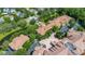 Stunning aerial view of a property with lush landscaping, parking, and proximity to a serene waterway at 502 Mirasol Cir # 103, Kissimmee, FL 34747