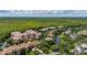 Aerial view of a multi-story condo surrounded by lush greenery and a beautiful stream at 502 Mirasol Cir # 103, Kissimmee, FL 34747