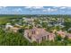 Stunning aerial view of community, showcasing lush landscaping, water features, and beautiful Mediterranean-style architecture at 502 Mirasol Cir # 103, Kissimmee, FL 34747